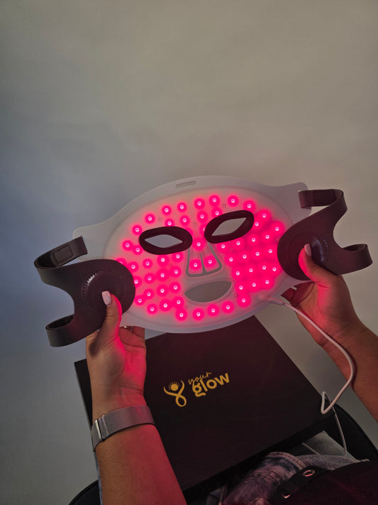Person holding a red light therapy LED mask 